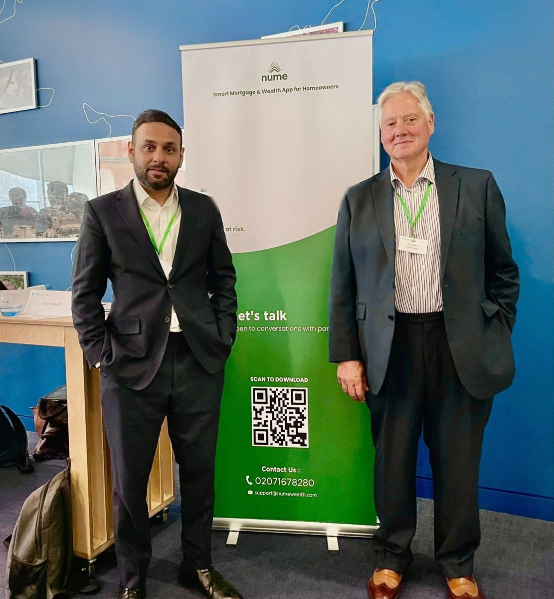 The nume team beside a nume banner at Barclays Demo Day